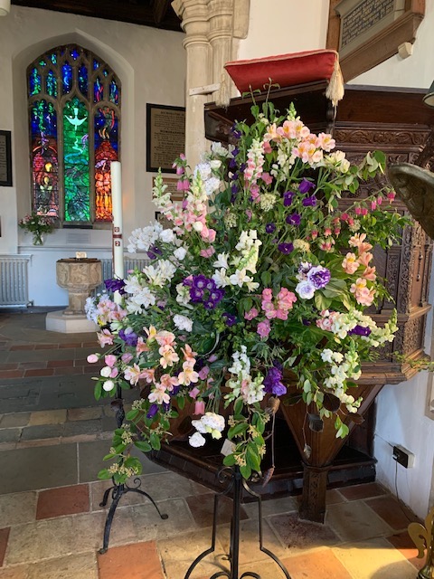 A bouquet of flowers in a church

Description automatically generated with medium confidence